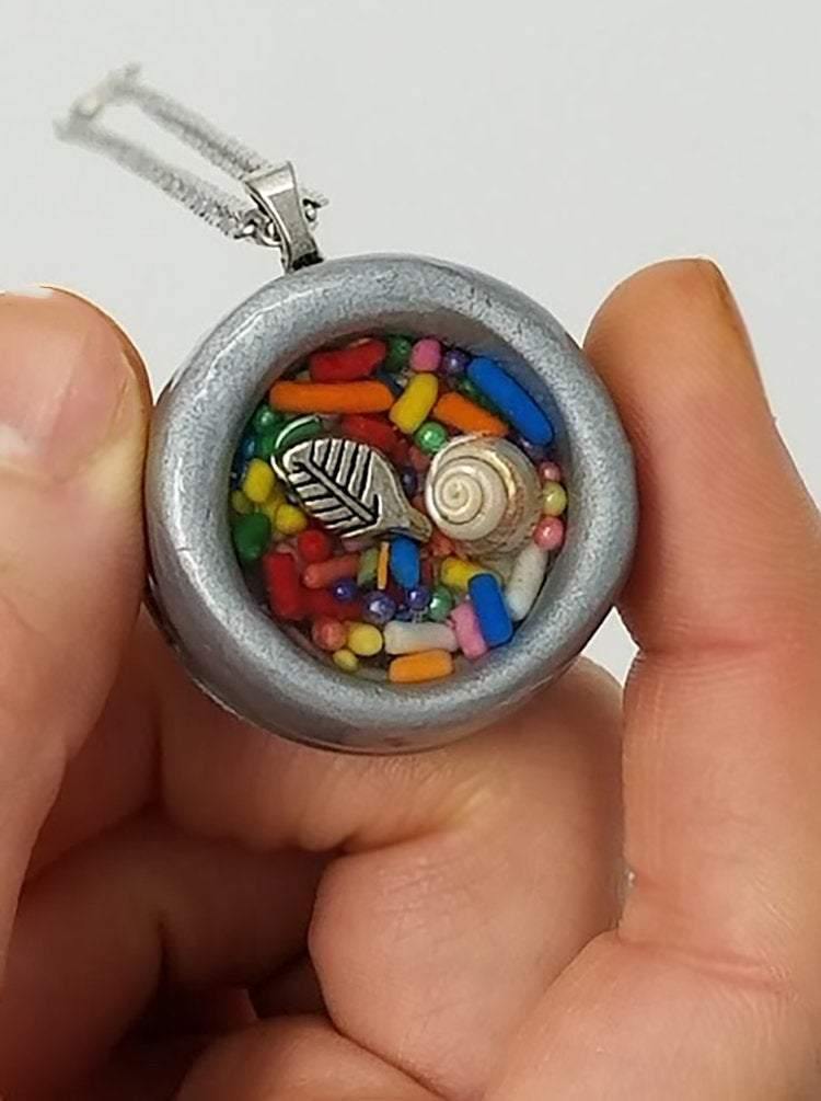 Round gray clay pendant filled with real candy sprinkles, metal leaf and tiny seashell immersed in resin - Includes chain - Curio Memento