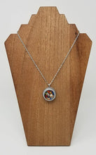 Load image into Gallery viewer, Round gray clay pendant filled with real candy sprinkles, metal leaf and tiny seashell immersed in resin - Includes chain - Curio Memento
